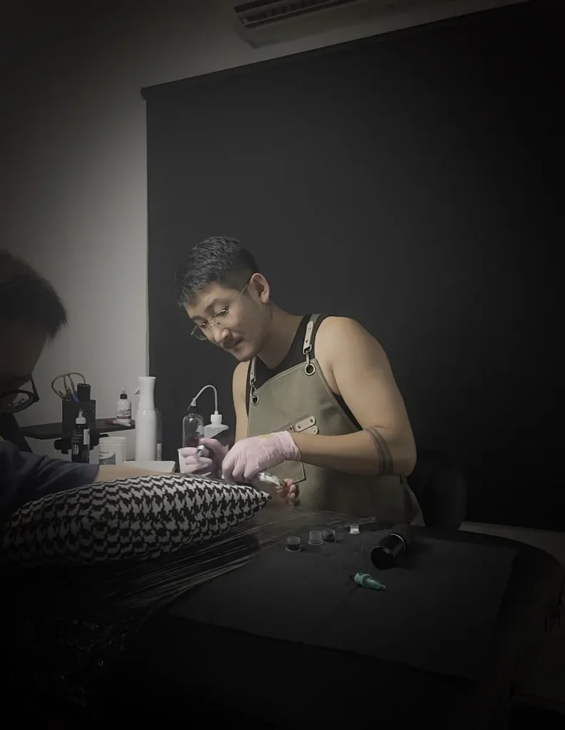 Yuyi working on a custom tattoo at his Geylang studio in Singapore