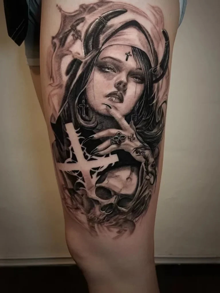 Black-and-grey horned female character tattoo on the thigh
