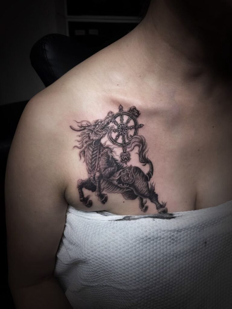 Hoofed mythical creature and circular motif tattoo across the upper chest