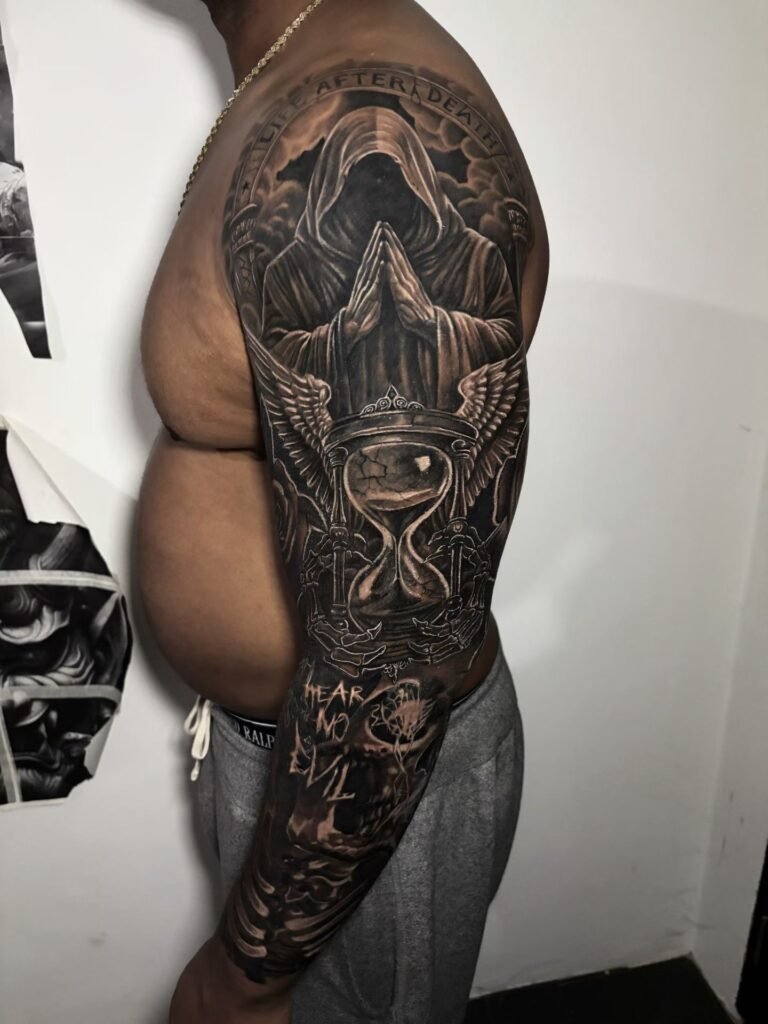 Black-and-grey sleeve with a hooded figure, hourglass and skull motifs
