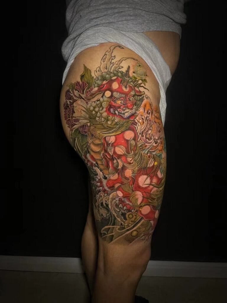 Red horned demon character in a colour thigh tattoo