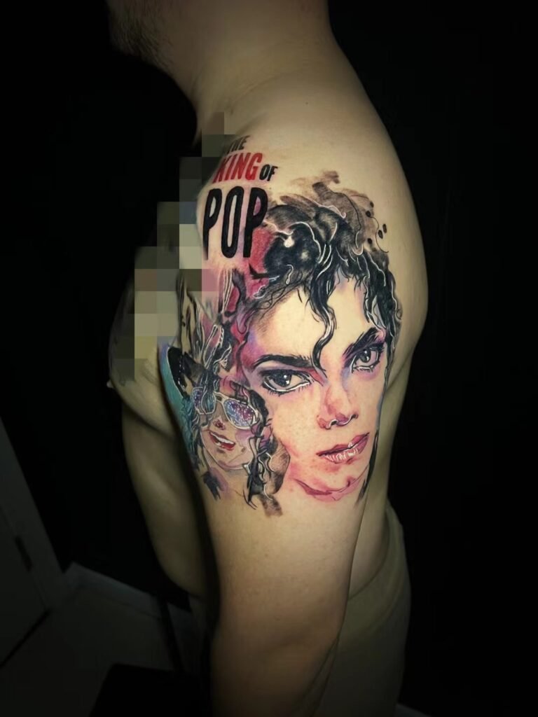 Colour portrait tattoo with bold graphic details on the upper arm